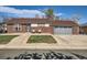 Charming brick home featuring a well-manicured lawn and an inviting two-car garage at 7120 Galapago St, Denver, CO 80221