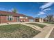 Charming brick home featuring a well-manicured lawn with inviting walkway at 7120 Galapago St, Denver, CO 80221