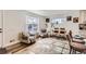 Open-concept living area with hardwood floors, modern furniture, and lots of natural light at 7120 Galapago St, Denver, CO 80221