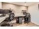 Well-lit home office featuring rustic wood paneling and built-in dual workstations at 7120 Galapago St, Denver, CO 80221