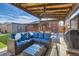 Covered patio featuring comfortable seating, a ceiling fan, and backyard views at 7120 Galapago St, Denver, CO 80221