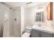 Bathroom featuring a step in shower, grab bars, a three light vanity, tile floors, and a toilet at 10298 W Dartmouth Ave, Lakewood, CO 80227