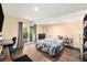 Bedroom featuring a sliding glass door to the outside, neutral colors, and hardwood floors at 10298 W Dartmouth Ave, Lakewood, CO 80227