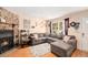Inviting living room featuring a cozy stone fireplace and a comfortable sectional sofa at 10298 W Dartmouth Ave, Lakewood, CO 80227