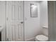 Compact bathroom features a toilet and mirror at 7870 W 87Th Dr # J, Arvada, CO 80005