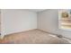 Carpeted bedroom featuring neutral tones and a large window for natural light at 7870 W 87Th Dr # J, Arvada, CO 80005