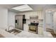 Well-lit kitchen with stainless steel appliances and white marble countertops at 7870 W 87Th Dr # J, Arvada, CO 80005