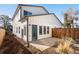An inviting outdoor patio area features a secure wood fence and an entrance into the home at 2952 S Delaware St, Englewood, CO 80110