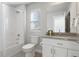 Bright bathroom featuring a shower, tub, and vanity with ample storage space at 2952 S Delaware St, Englewood, CO 80110