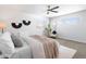 Bright bedroom with a ceiling fan and plush bedding at 2952 S Delaware St, Englewood, CO 80110
