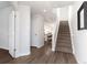 Inviting entryway featuring wood floors, a staircase, and access to the kitchen at 2952 S Delaware St, Englewood, CO 80110