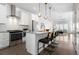 Open concept kitchen and living room with stainless steel appliances and island with seating at 2952 S Delaware St, Englewood, CO 80110