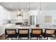 Bright kitchen features an island with bar seating and modern stainless steel appliances at 2952 S Delaware St, Englewood, CO 80110