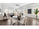 Bright living room featuring a round dining table, modern furnishings, and large windows at 2952 S Delaware St, Englewood, CO 80110