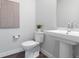 Clean, modern powder room with pedestal sink and stylish decor at 2952 S Delaware St, Englewood, CO 80110