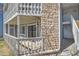 Close-up of the condo's balcony and stone-accented facade at 8335 Fairmount Dr # 102, Denver, CO 80247
