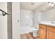 Bathroom with white tile in the shower, a wood vanity, and neutral floor tiles at 8335 Fairmount Dr # 102, Denver, CO 80247