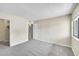 Bright bedroom with neutral carpet, natural light through a window, and an attached closet at 8335 Fairmount Dr # 102, Denver, CO 80247