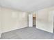 Spacious bedroom with neutral carpet and paint, a walk-in closet, and an open floor plan at 8335 Fairmount Dr # 102, Denver, CO 80247