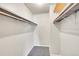 Walk-in closet with neutral carpet, and built in shelving and racks for storage at 8335 Fairmount Dr # 102, Denver, CO 80247