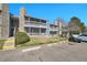 Exterior view of a two-story condo complex featuring balconies and stone accents at 8335 Fairmount Dr # 102, Denver, CO 80247
