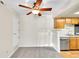 Cozy kitchen with wooden cabinets and stainless-steel dishwasher at 8335 Fairmount Dr # 102, Denver, CO 80247