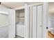 Open view of the laundry closet, with the washer and dryer, and next to the bathroom at 8335 Fairmount Dr # 102, Denver, CO 80247