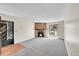 View of the living room with a stone fireplace and exterior door at 8335 Fairmount Dr # 102, Denver, CO 80247