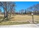 Community green space with mature shade trees and bench at 8335 Fairmount Dr # 102, Denver, CO 80247