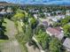 Aerial view of the neighborhood showcasing mature trees, walking paths, and a mix of homes, set against a mountain backdrop at 10032 Astoria Ct, Lone Tree, CO 80124