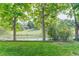 Enjoy the lush backyard with green lawn, mature trees, and a charming white fence, offering a serene outdoor space at 10032 Astoria Ct, Lone Tree, CO 80124