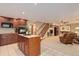 Spacious finished basement featuring a kitchen, living area, and staircase, perfect for entertaining and relaxation at 10032 Astoria Ct, Lone Tree, CO 80124