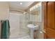 Clean bathroom featuring a glass-enclosed shower, pedestal sink, and tiled floor for a fresh and modern feel at 10032 Astoria Ct, Lone Tree, CO 80124