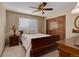 Cozy bedroom featuring wood furniture, ceiling fan, closet and large window at 10032 Astoria Ct, Lone Tree, CO 80124