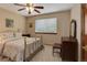 Cozy bedroom with a comfortable bed, side table, and dresser at 10032 Astoria Ct, Lone Tree, CO 80124