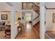 Elegant foyer with hardwood floors, staircase, and views into the living room and office areas at 10032 Astoria Ct, Lone Tree, CO 80124