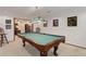 Inviting game room features a classic billiards table and adjacent seating area, perfect for entertaining guests at 10032 Astoria Ct, Lone Tree, CO 80124