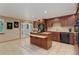 Bright kitchen with dark appliances, functional island, and access to outdoor area, great for indoor-outdoor living at 10032 Astoria Ct, Lone Tree, CO 80124