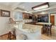 Well-lit kitchen with wood cabinets, stainless steel appliances, granite countertops and an island at 10032 Astoria Ct, Lone Tree, CO 80124