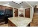 Open kitchen area with a large granite island, modern appliances, and dark wood cabinetry at 10032 Astoria Ct, Lone Tree, CO 80124