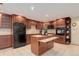 Charming kitchen with wooden cabinetry, functional island, and tile flooring, perfect for cooking and gatherings at 10032 Astoria Ct, Lone Tree, CO 80124
