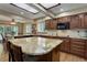 Spacious kitchen features wood cabinets, stainless steel appliances, and a granite-topped island at 10032 Astoria Ct, Lone Tree, CO 80124