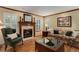 Comfortable living room with fireplace, wooden trim, and hardwood flooring at 10032 Astoria Ct, Lone Tree, CO 80124