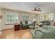 Inviting living room featuring hardwood floors, plantation shutters, and comfortable leather furniture at 10032 Astoria Ct, Lone Tree, CO 80124