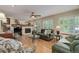Comfortable living room with a fireplace, hardwood floors, plantation shutters and leather seating at 10032 Astoria Ct, Lone Tree, CO 80124