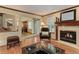 Charming living room featuring a fireplace, hardwood floors, and an open layout with natural light at 10032 Astoria Ct, Lone Tree, CO 80124