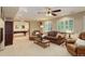 Comfortable living room in the basement with plush seating, a ceiling fan, and natural light from the windows at 10032 Astoria Ct, Lone Tree, CO 80124