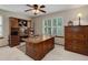 Home office with wood furnishings, a large desk, and a window with plantation shutters at 10032 Astoria Ct, Lone Tree, CO 80124
