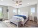 Serene primary bedroom with wood-look floors and natural light from the large windows at 16611 E 119Th Ave # E, Commerce City, CO 80022