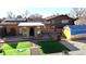 An elevated view of backyard with patio, updated landscaping, and unique structures for creative storage at 860 S 7Th Ave, Brighton, CO 80601